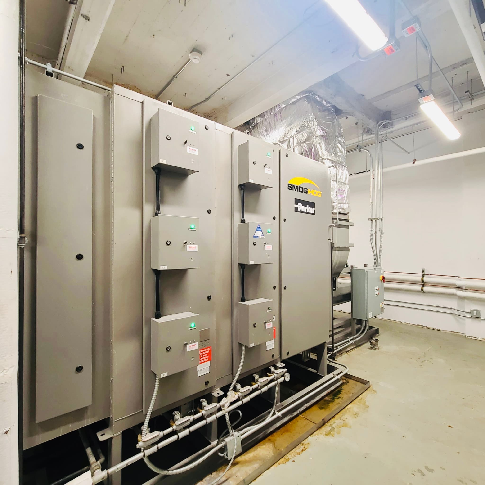 SMOG-HOG and Parker filtration equipment in a commercial mechanical room